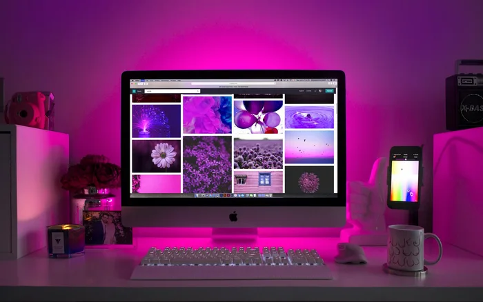 Desktop workspace with an illuminated monitor displaying visual content